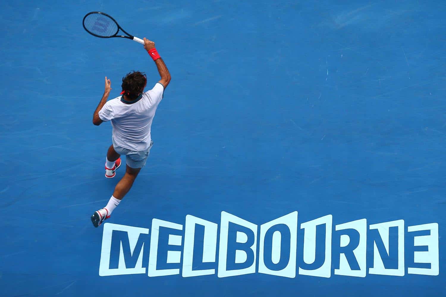 MELBOURNE, AUSTRALIA - JANUARY 18: Roger Federer of Switzerland plays a forehand in his third round match against Teymuraz Gabashvili of Russia during day six of the 2014 Australian Open at Melbourne Park on January 18, 2014 in Melbourne, Australia. (Photo by Ryan Pierse/Getty Images)